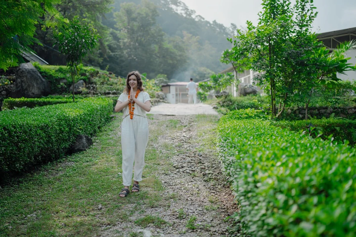 A participant in walking meditation with a mala through the Adhiroha ashram gardens