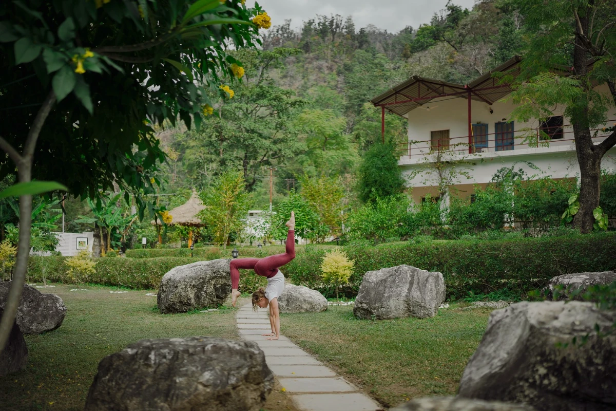 The green Adhiroha ashram held by the forested Himalayan foothills