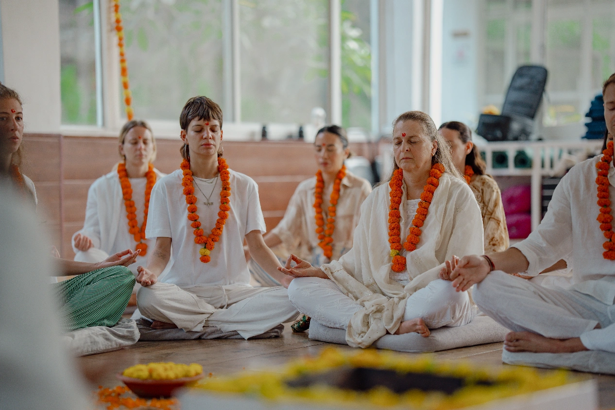 Students garlanded in marigold during a ceremony at the ashram