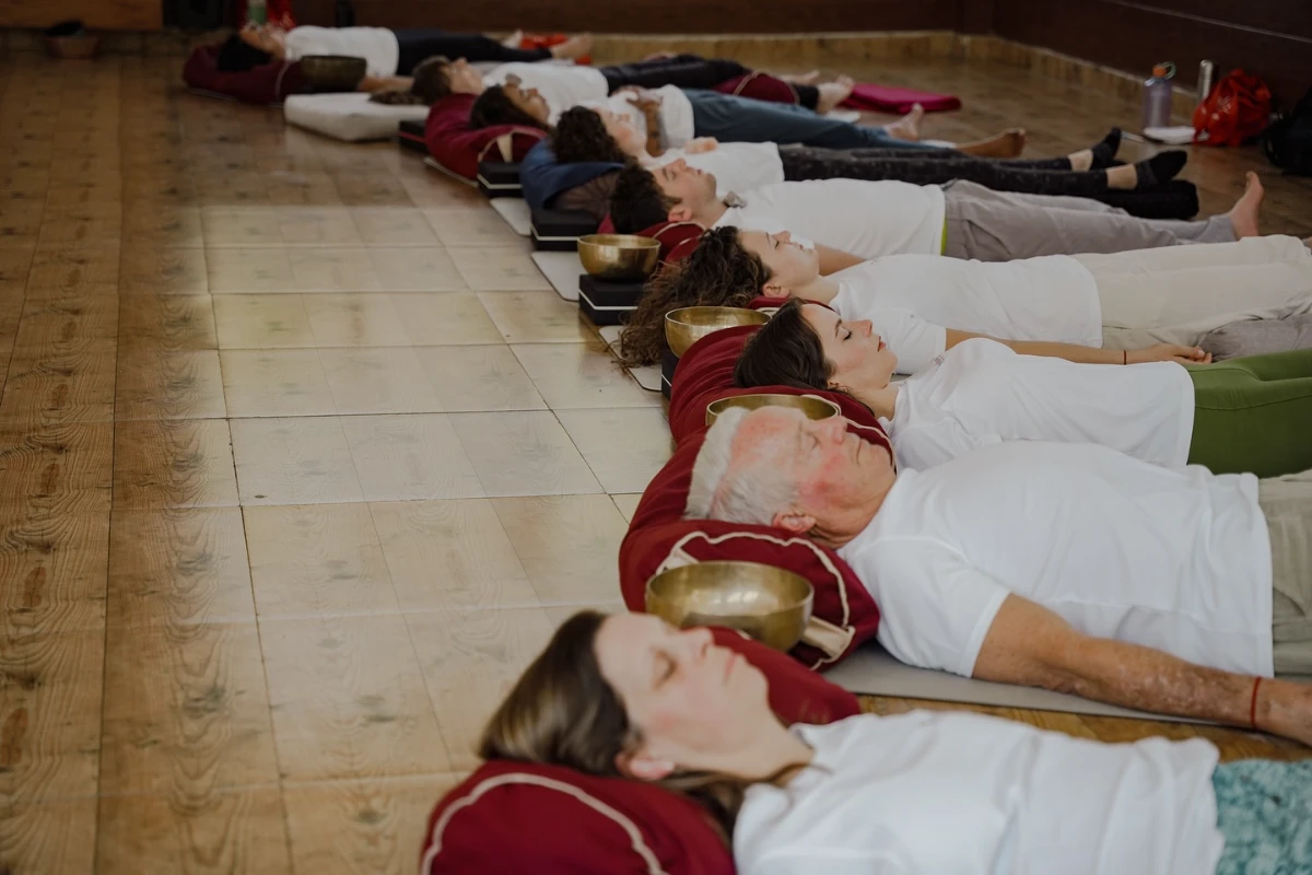 Students resting deeply in rows during a Tibetan bowl sound bath