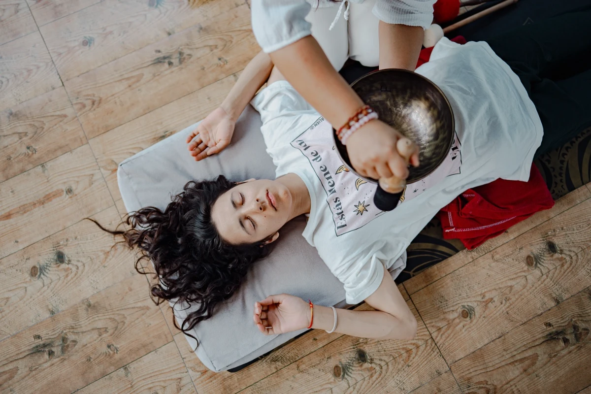 A large Tibetan bowl played over the body during a therapeutic session
