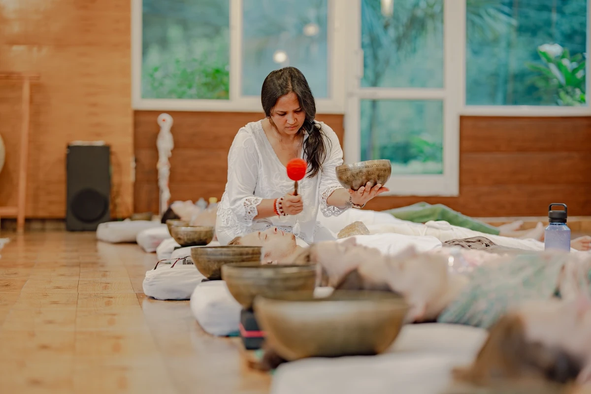 Megha, the Adhiroha sound healing instructor, guiding a bowl therapy session