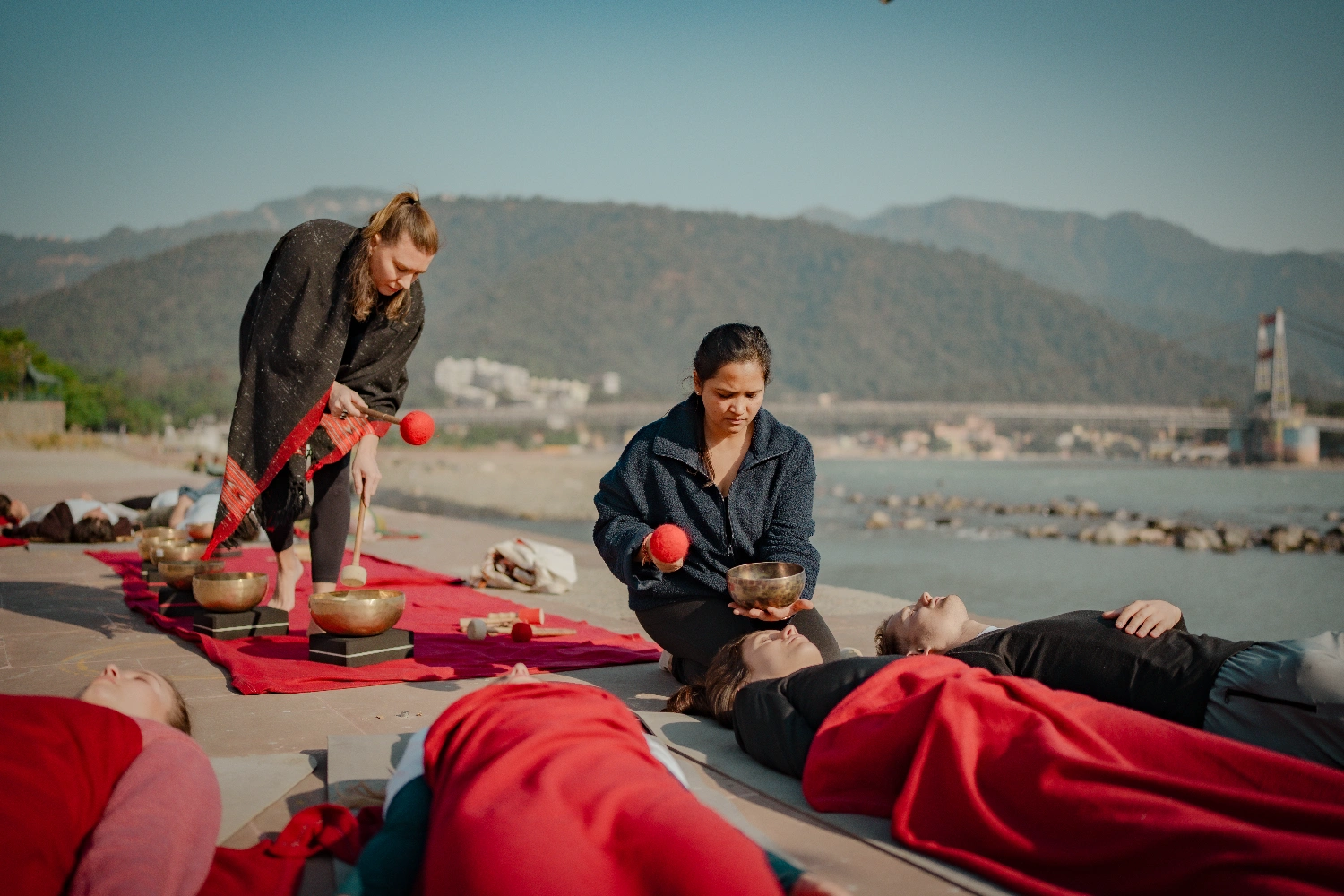 A sound healing session with Tibetan singing bowls on the Ganga Ji  ghat in Rishikesh