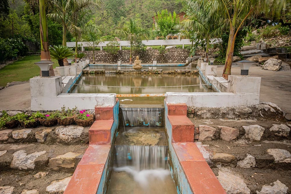 Natural spring water running through the green Adhiroha ashram