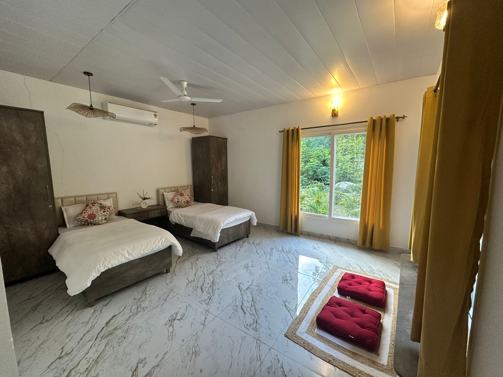 Clean, spacious student room with fresh linens at the Adhiroha yoga ashram in Rishikesh