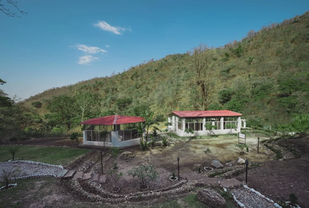 Aerial view of the Adhiroha ashram resting in the green hills of Upper Tapovan