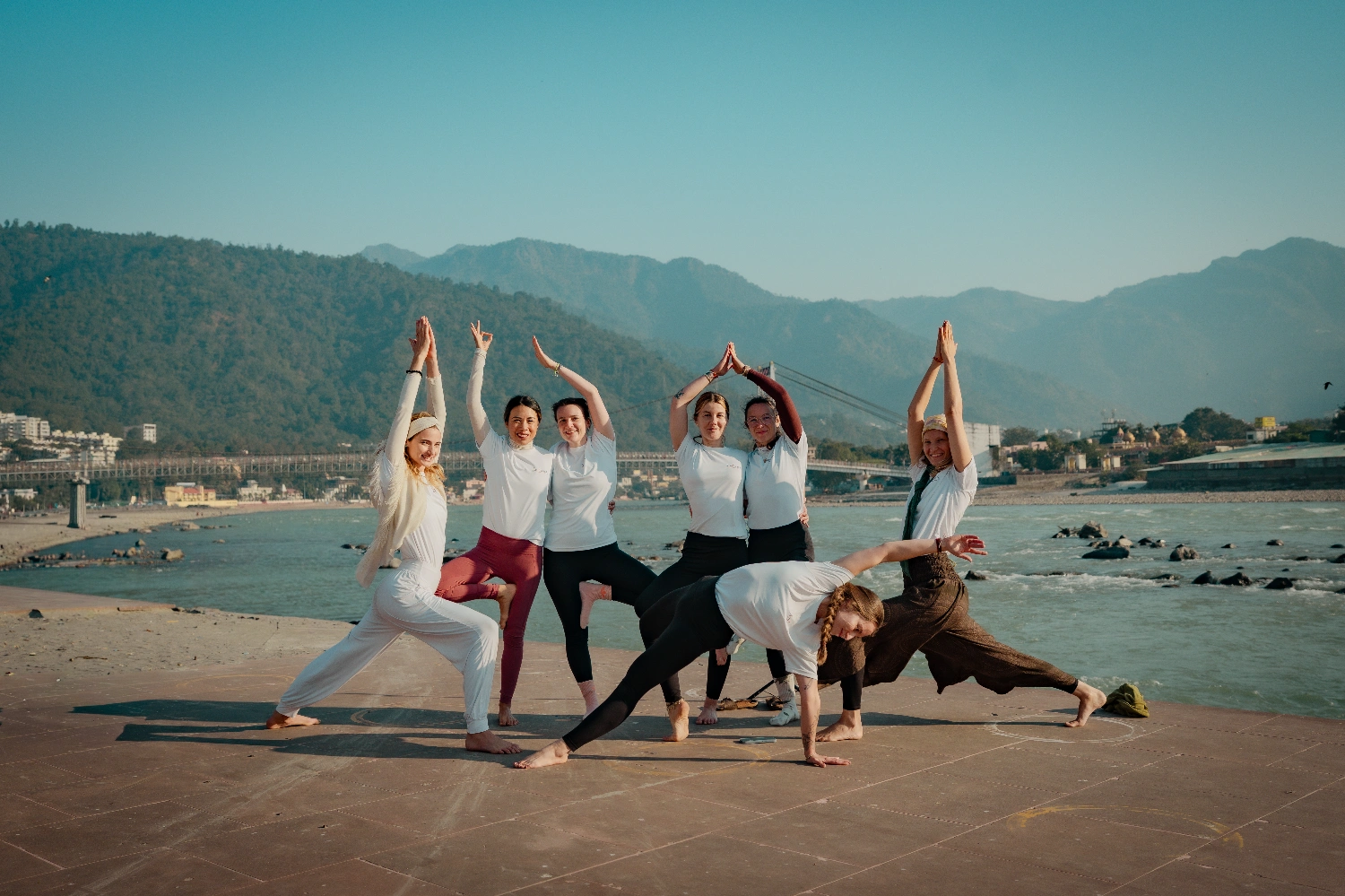 Yoga practice on the banks of the Ganga Ji at Rishikesh with the mountains behind