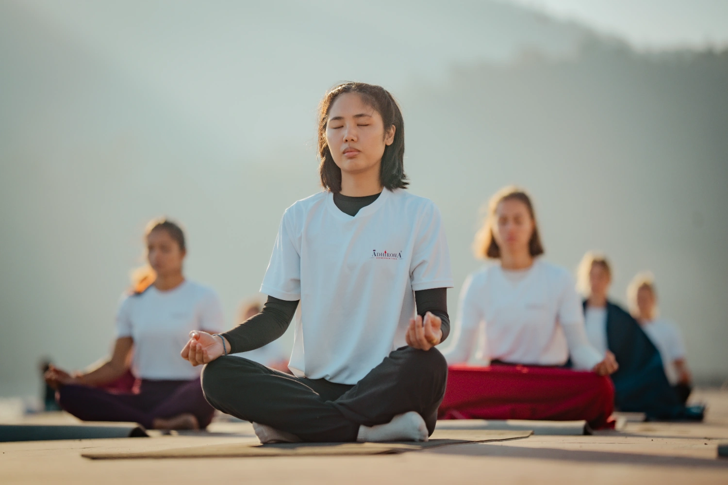 Silent sunrise meditation rows inside the Adhiroha yoga shala in Rishikesh