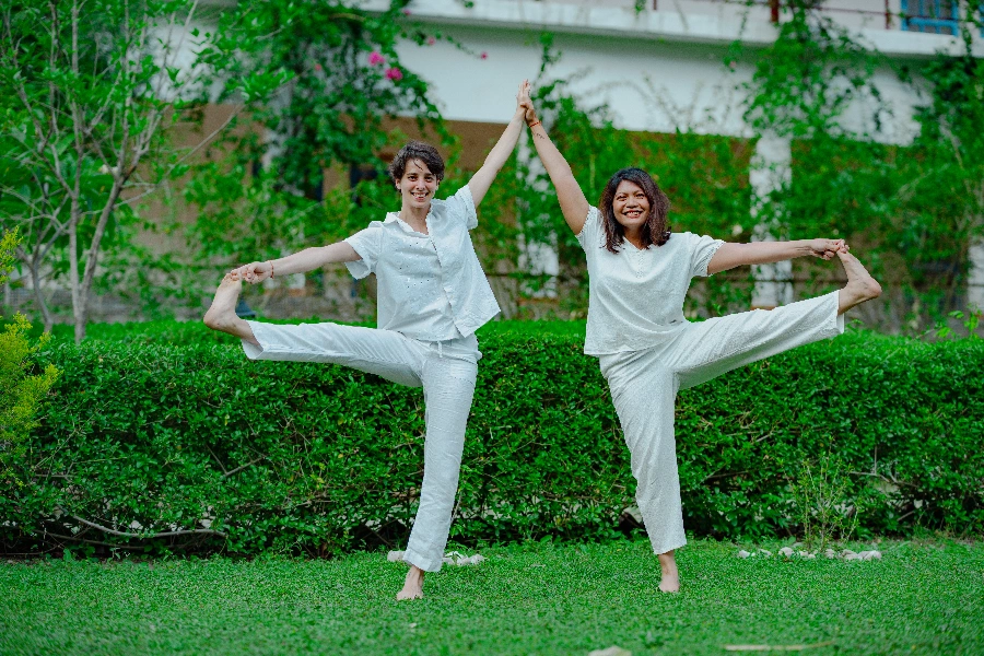 employees practising stress relief yoga at their desks